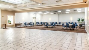 A large conference room with a whiteboard, multiple tables with chairs, and a carpeted floor. - Motel 6 Brunswick, GA (Brunswick)