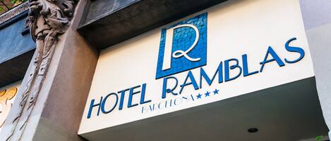 A hotel sign with the name "HOTEL RAMBLAS" and the word "BARCELONA" below it.