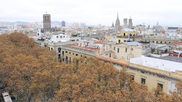 A cityscape with a mix of historical and modern buildings, including a prominent tower and a cathedral.