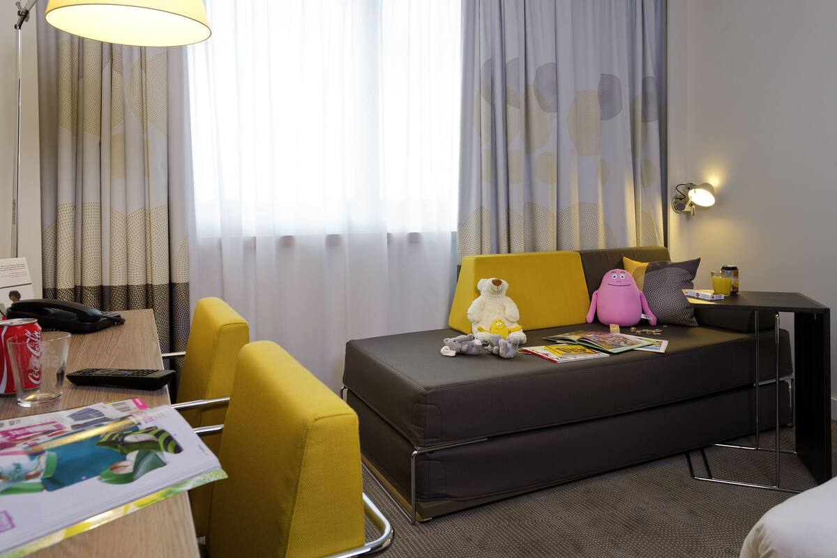 superior room, multiple beds (premium) | living area | lcd tv