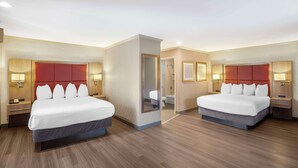 A hotel room with two beds, wooden flooring, and modern decor. - Best Western Inn (Santa Cruz)