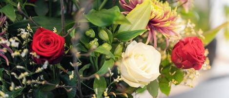 A bouquet of flowers with roses and other blooms.