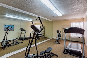 A gym with exercise equipment including treadmills, an elliptical, and a stationary bike. - Red Roof Inn Nashville - Music City (Nashville)