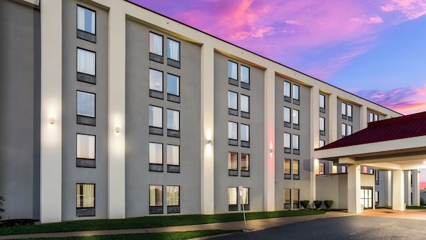 A modern hotel building with multiple floors, large windows, and a well-lit entrance. - Red Roof Inn Nashville - Music City (Nashville)
