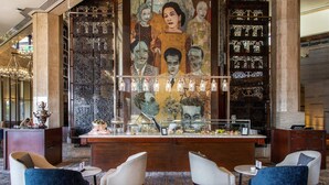 A lobby with a bar area, seating, and a decorative mural. - Intercontinental Cairo Semiramis by IHG (Cairo)
