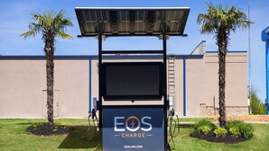 A charging station with a solar panel and a sign that reads "EOS CHARGE". - Days Inn by Wyndham Acworth (Acworth)