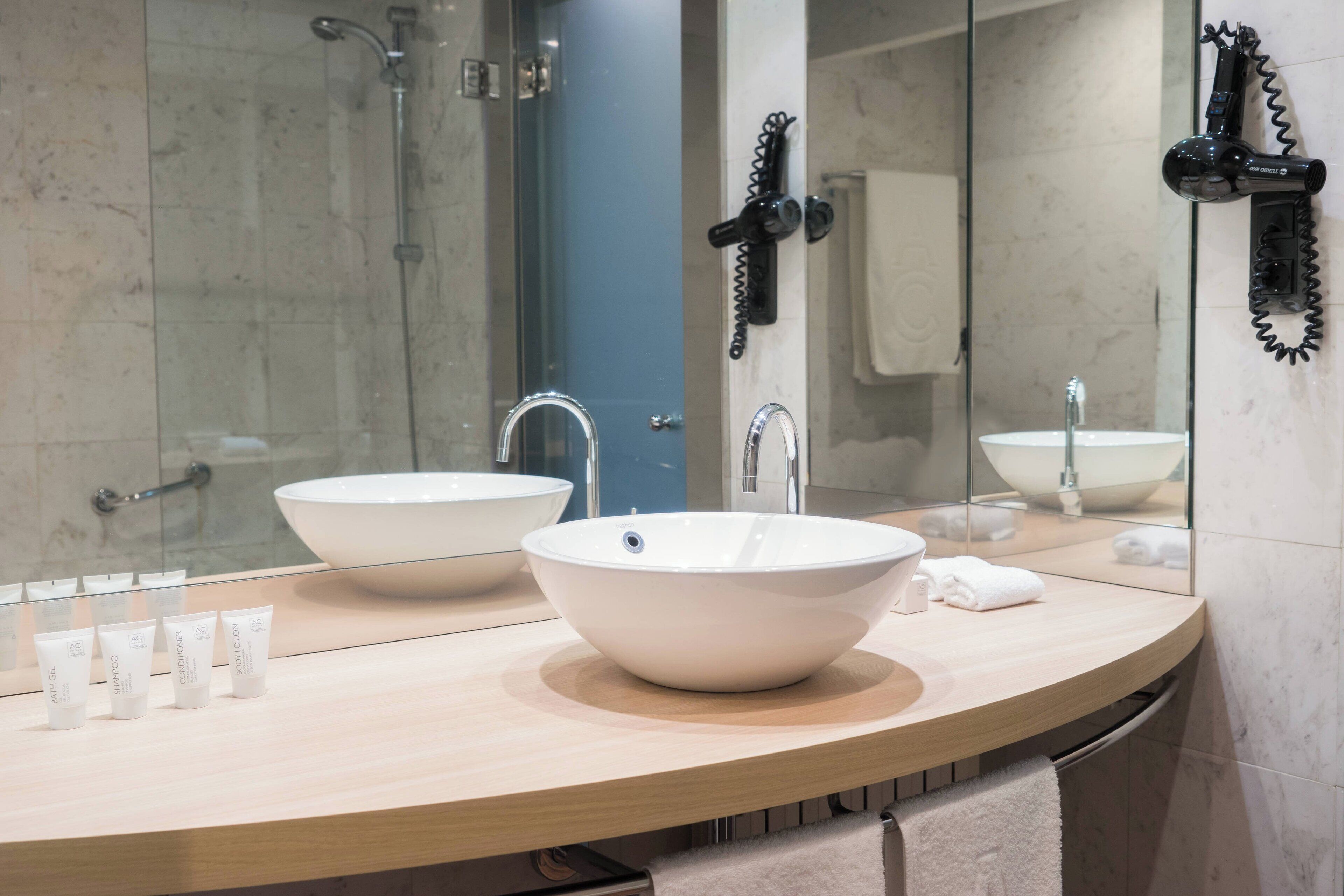 designer toiletries, hair dryer, towels