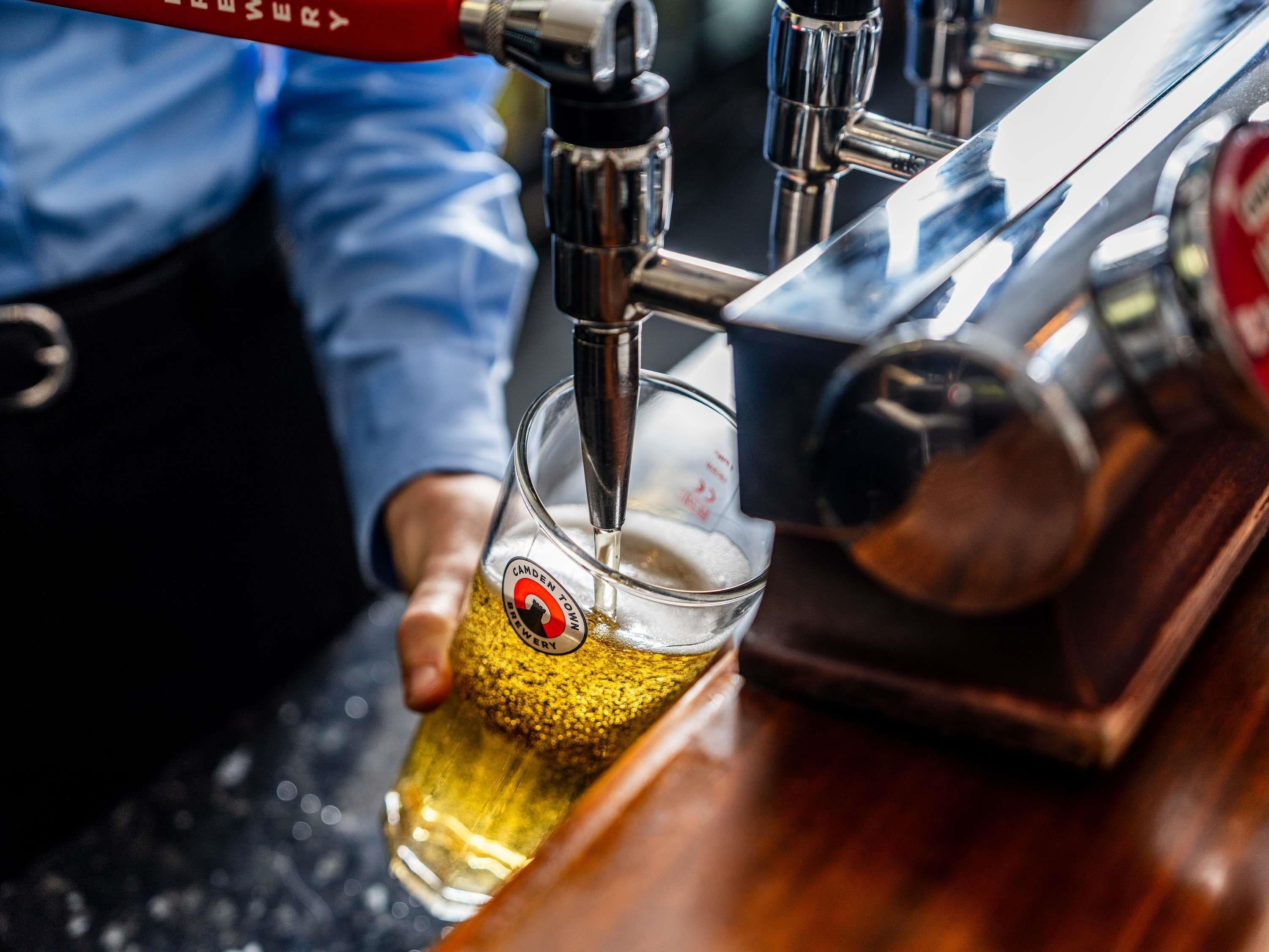 A tap dispensing beer into a glass.