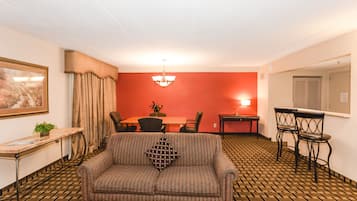 1 King Bed Business Suite | Living area | TV