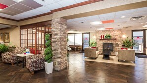 A spacious lobby with a stone pillar, a fireplace, and comfortable seating areas. - Ramada Hotel & Conference Center by Wyndham Plymouth (Plymouth)