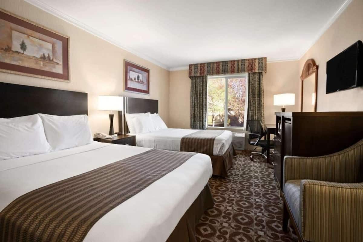 Premium bedding, desk, laptop workspace, blackout drapes
