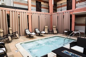 Relax by the pool surrounded by comfortable lounge chairs and tables.