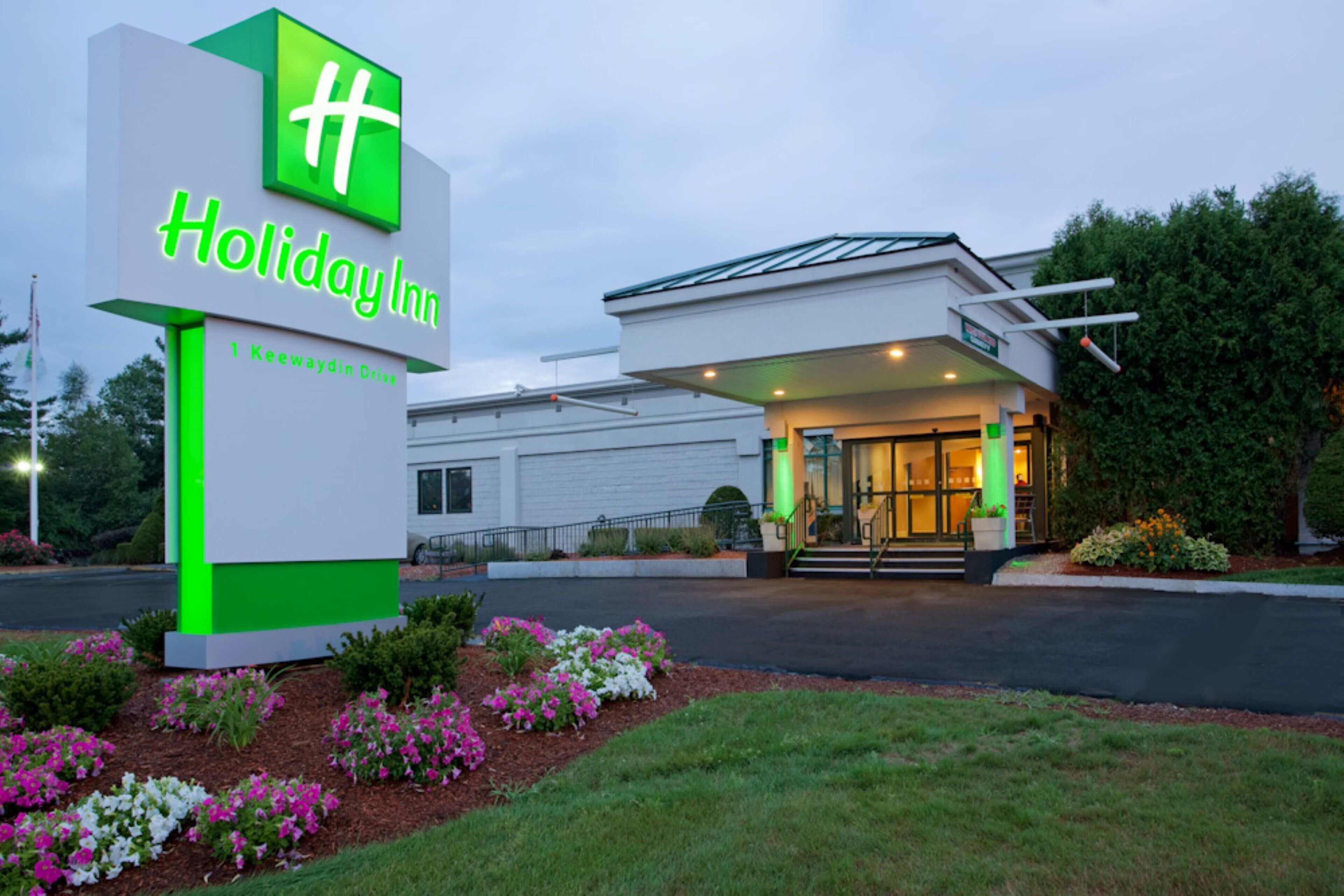 A Holiday Inn sign with a modern building entrance.