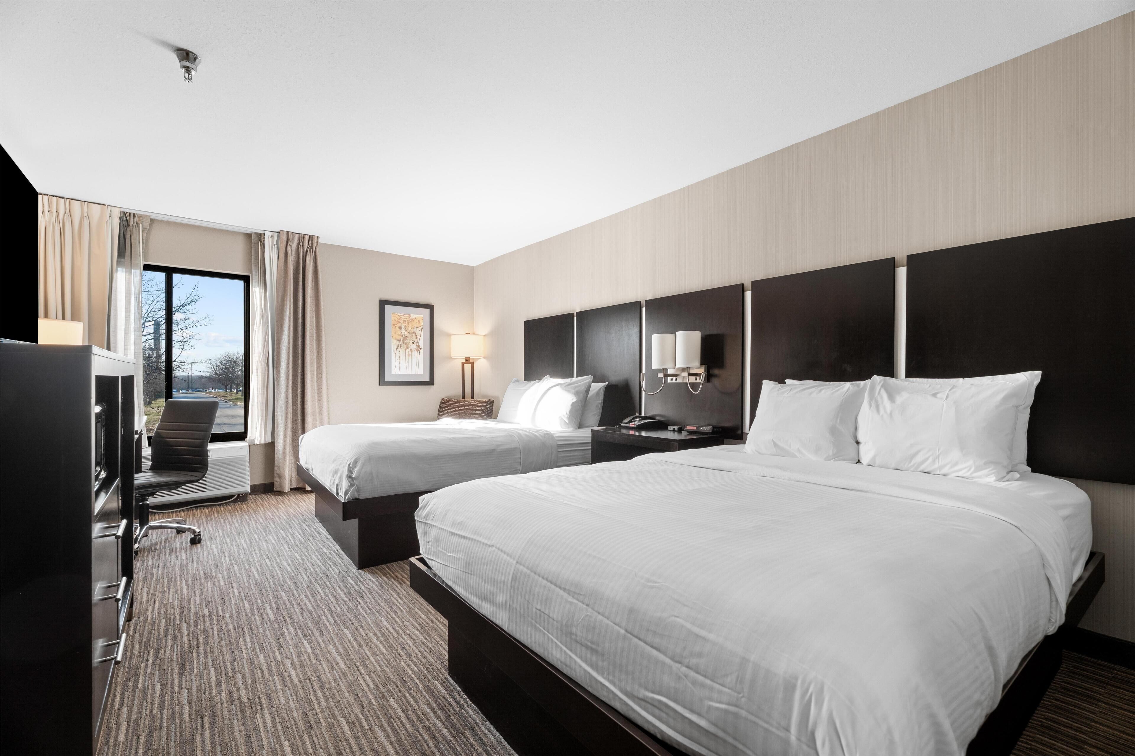 Premium bedding, desk, laptop workspace, blackout drapes