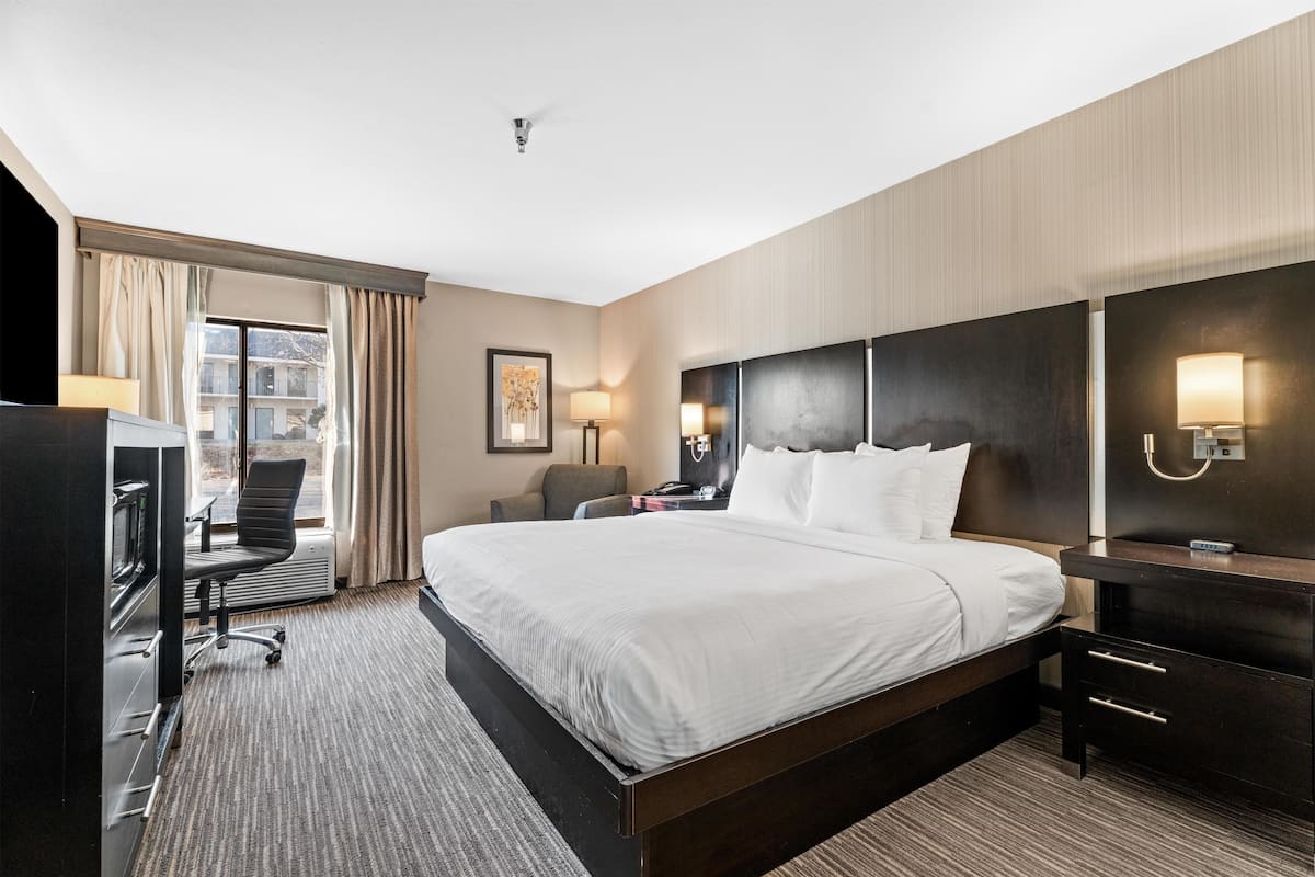 Premium bedding, desk, laptop workspace, blackout drapes