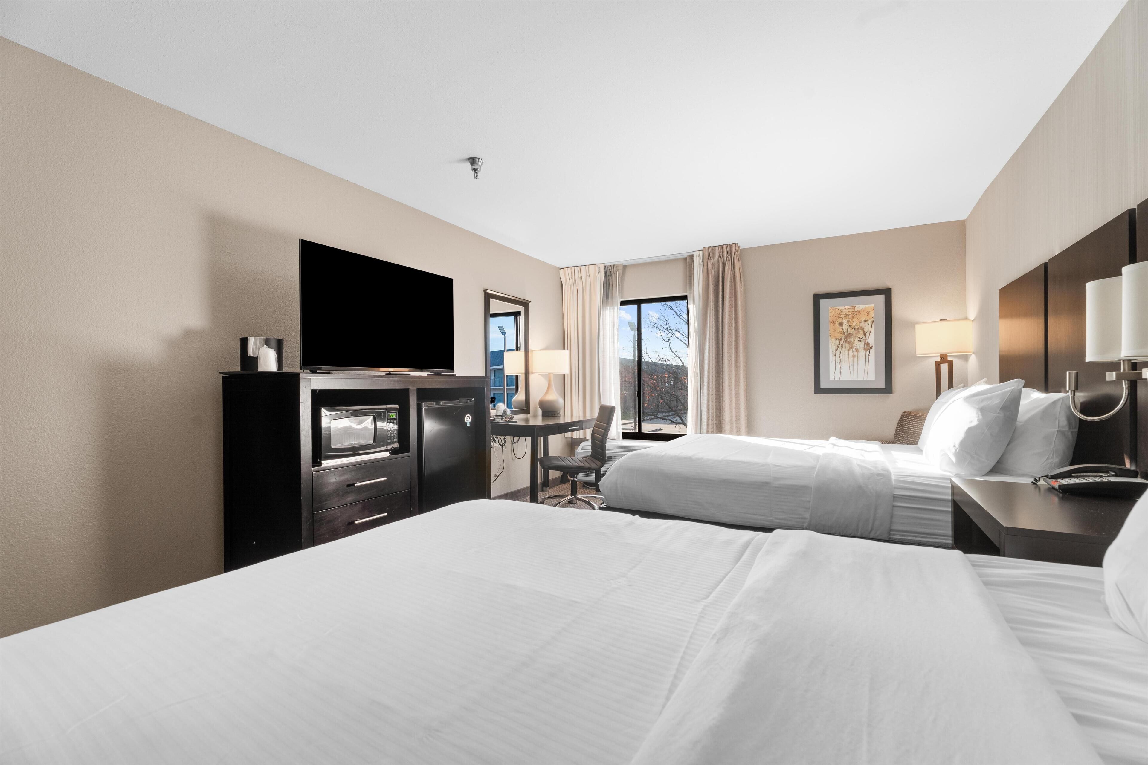 Premium bedding, desk, laptop workspace, blackout drapes