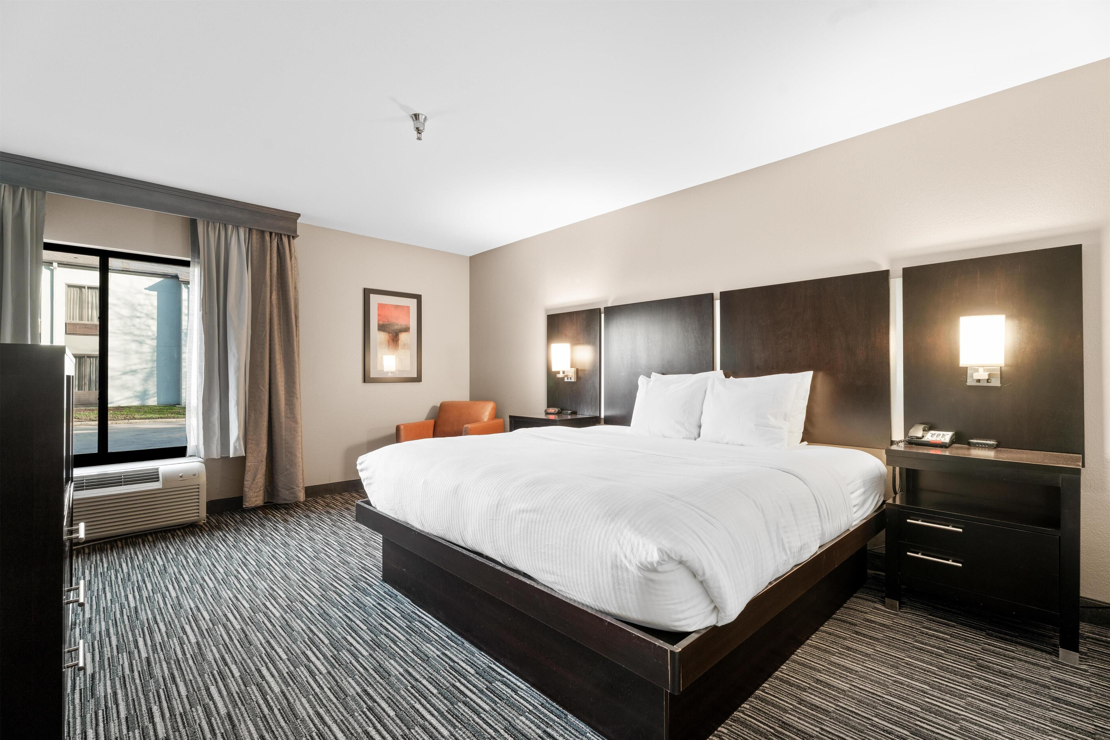 Premium bedding, desk, laptop workspace, blackout drapes