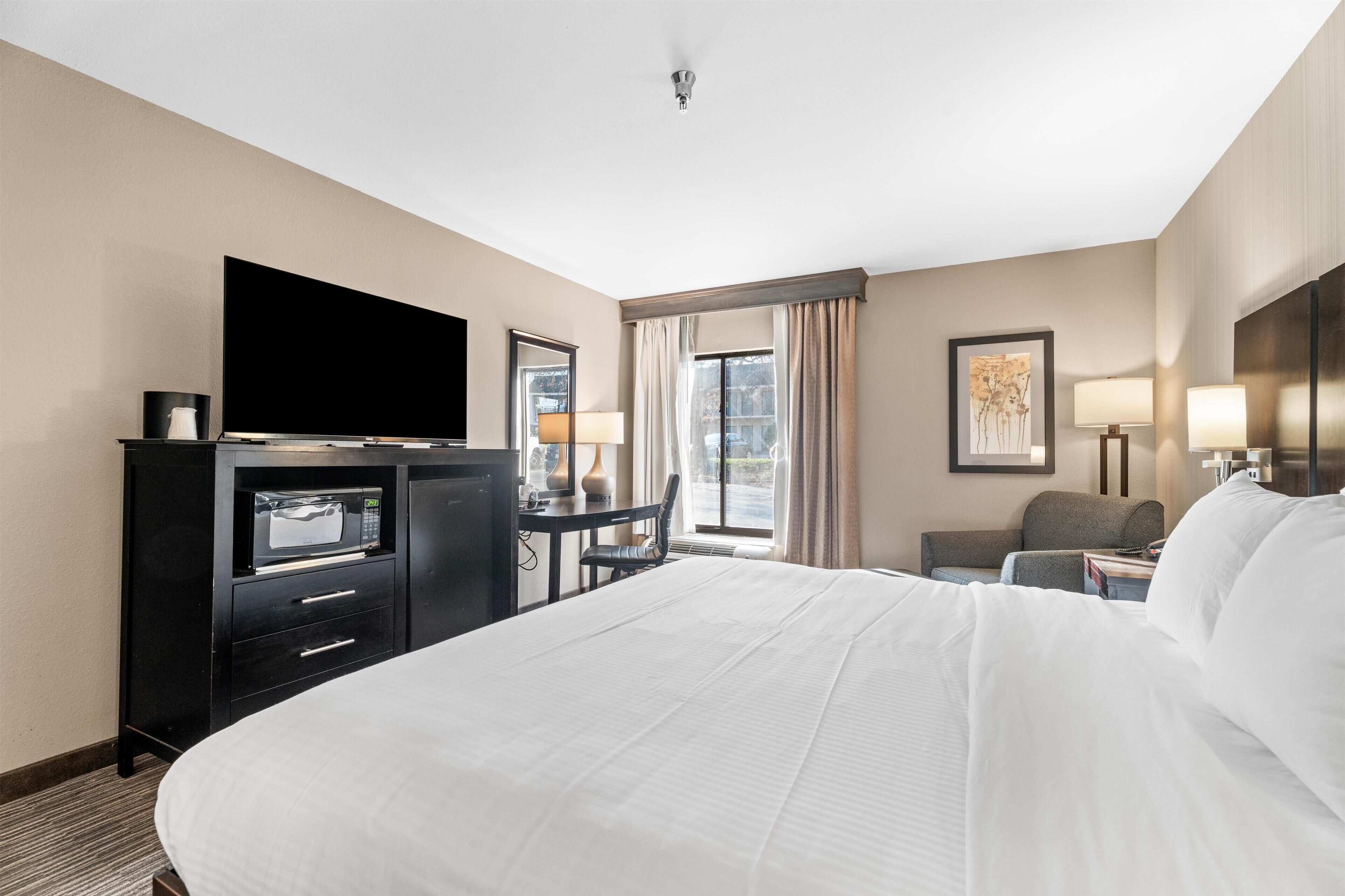 Premium bedding, desk, laptop workspace, blackout drapes