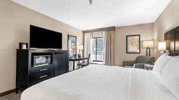 Premium bedding, desk, laptop workspace, blackout drapes