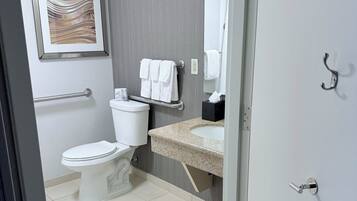 A modern bathroom with a toilet, sink, and towel rack.