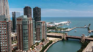 A high-rise building complex with a waterfront marina and a bridge.