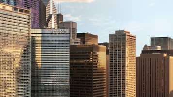 A cityscape with modern high-rise buildings, a river, and a bridge.