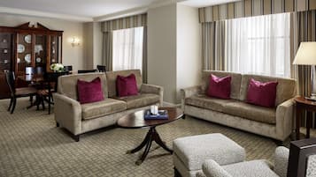 A living room with two sofas, a coffee table, and a patterned carpet.