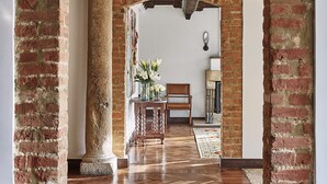 An interior hallway with exposed brick arches, wooden flooring, and a view into a room with a chair and a table. - Four Seasons Hotel Bogotá Casa Medina (Bogotá)