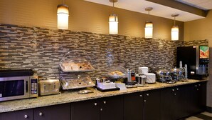 A buffet counter with a microwave, toaster, and coffee maker.