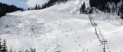 A ski resort with a chairlift, ski slopes, and a lodge.