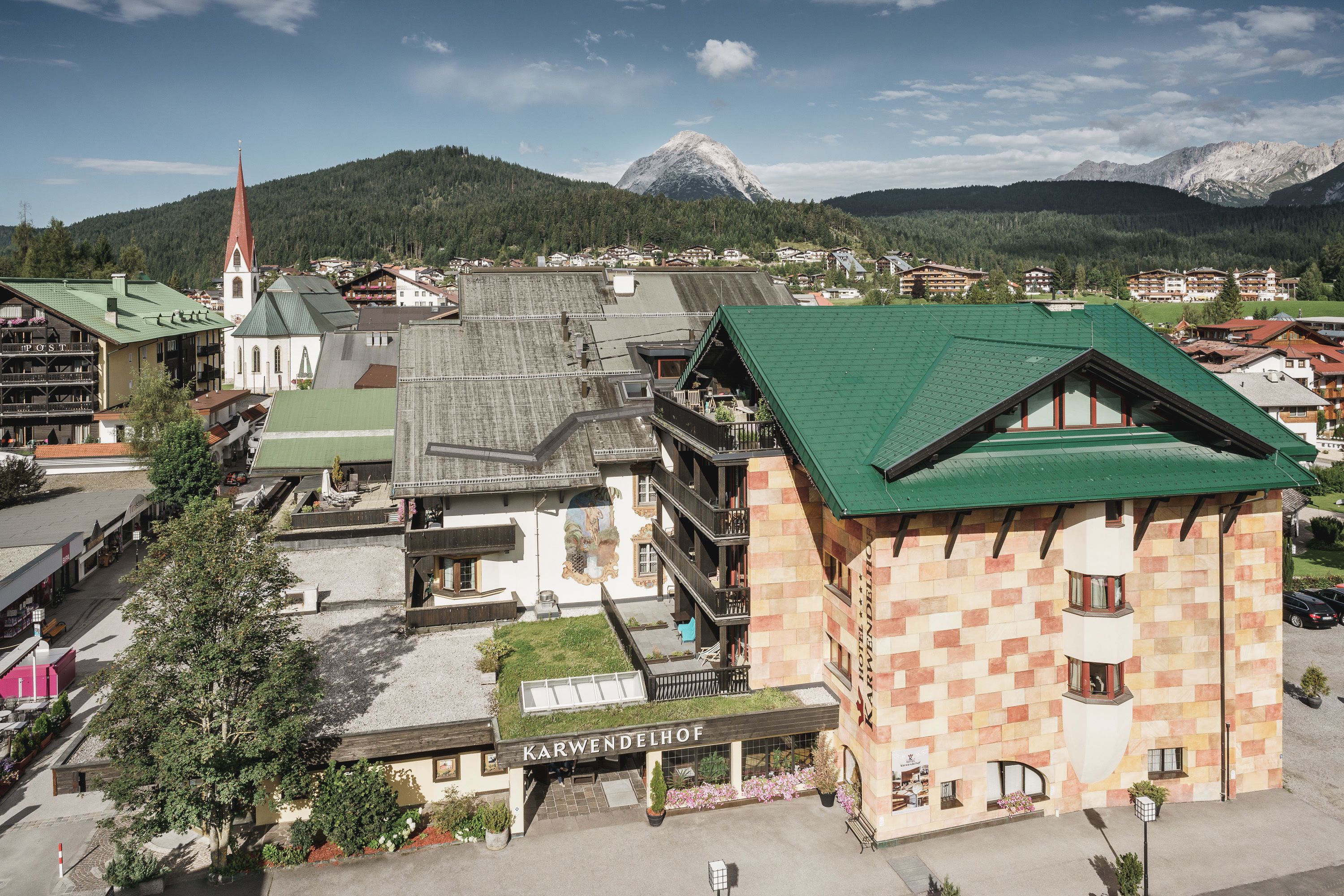 A building with a green roof and a sign reading "Karwendelhof".