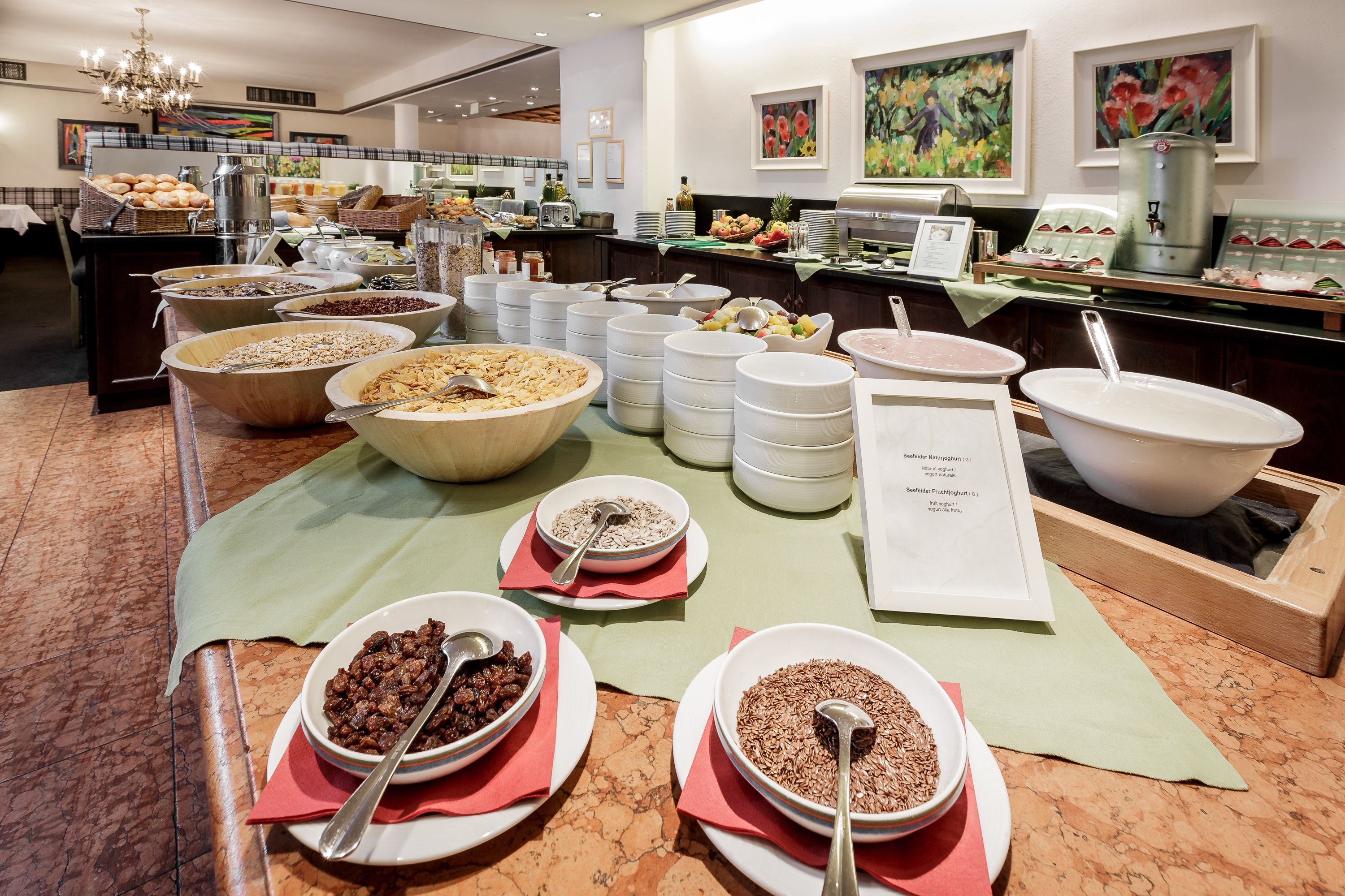A buffet setup with various food items and serving utensils.