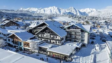 Experience the charm of traditional Alpine architecture amidst snow-covered mountains.