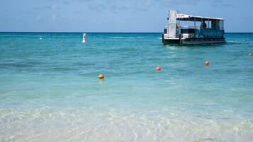 On the beach, white sand, beach towels, waterskiing