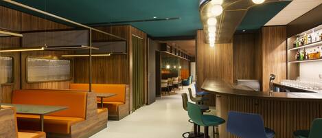 A modern bar area with wooden paneling, bar stools, and a counter with bottles.