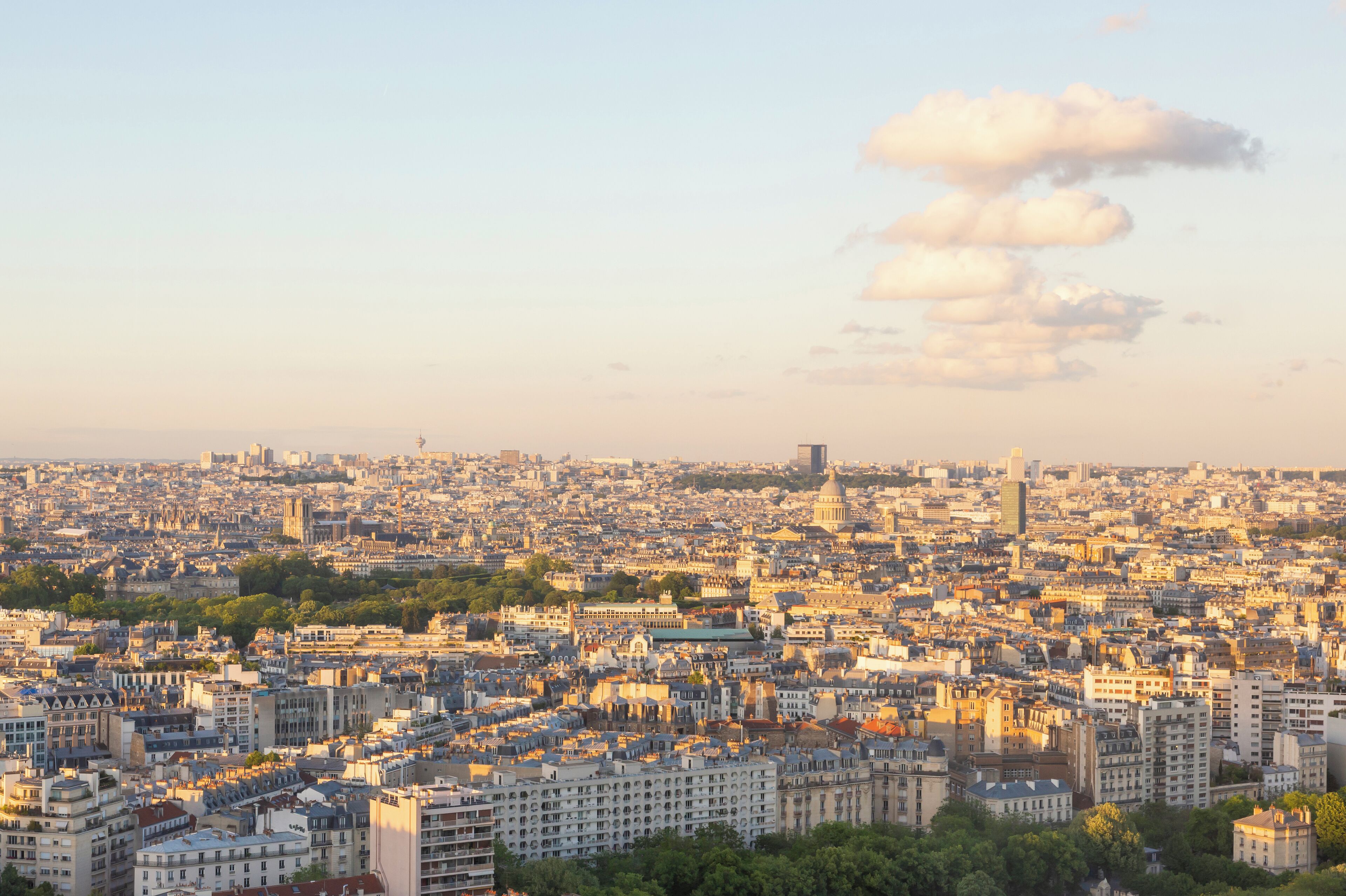A panoramic view of a densely populated cityscape with numerous buildings and a prominent dome structure.