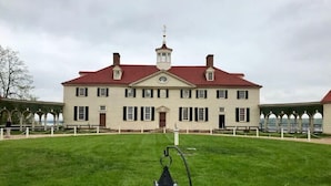 A large, historic building with a symmetrical facade, a central entrance, and a tower with a weathervane. - Holiday Inn Express Washington DC SW - Springfield by IHG (Springfield)