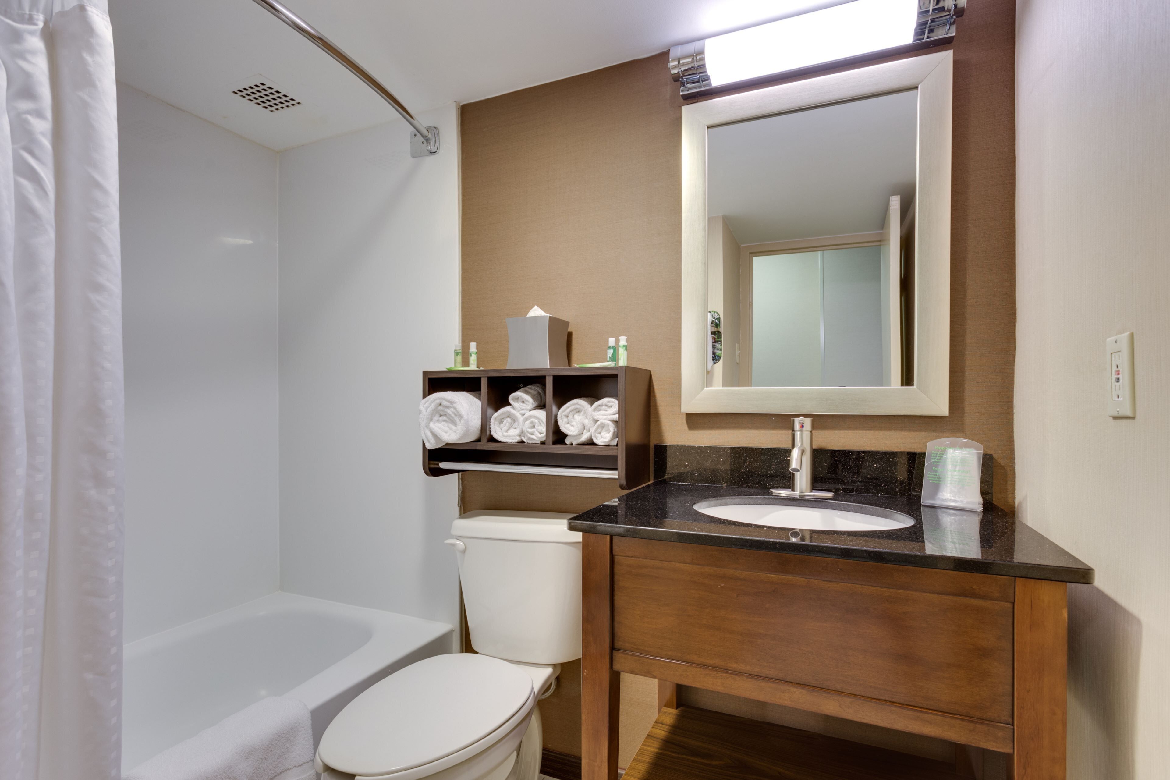 A bathroom with a toilet, a sink, and a shower.
