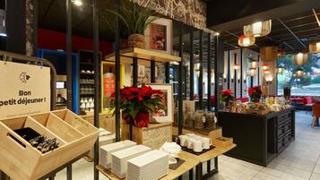 A breakfast buffet setup with wooden tables, plates, and a variety of food items.