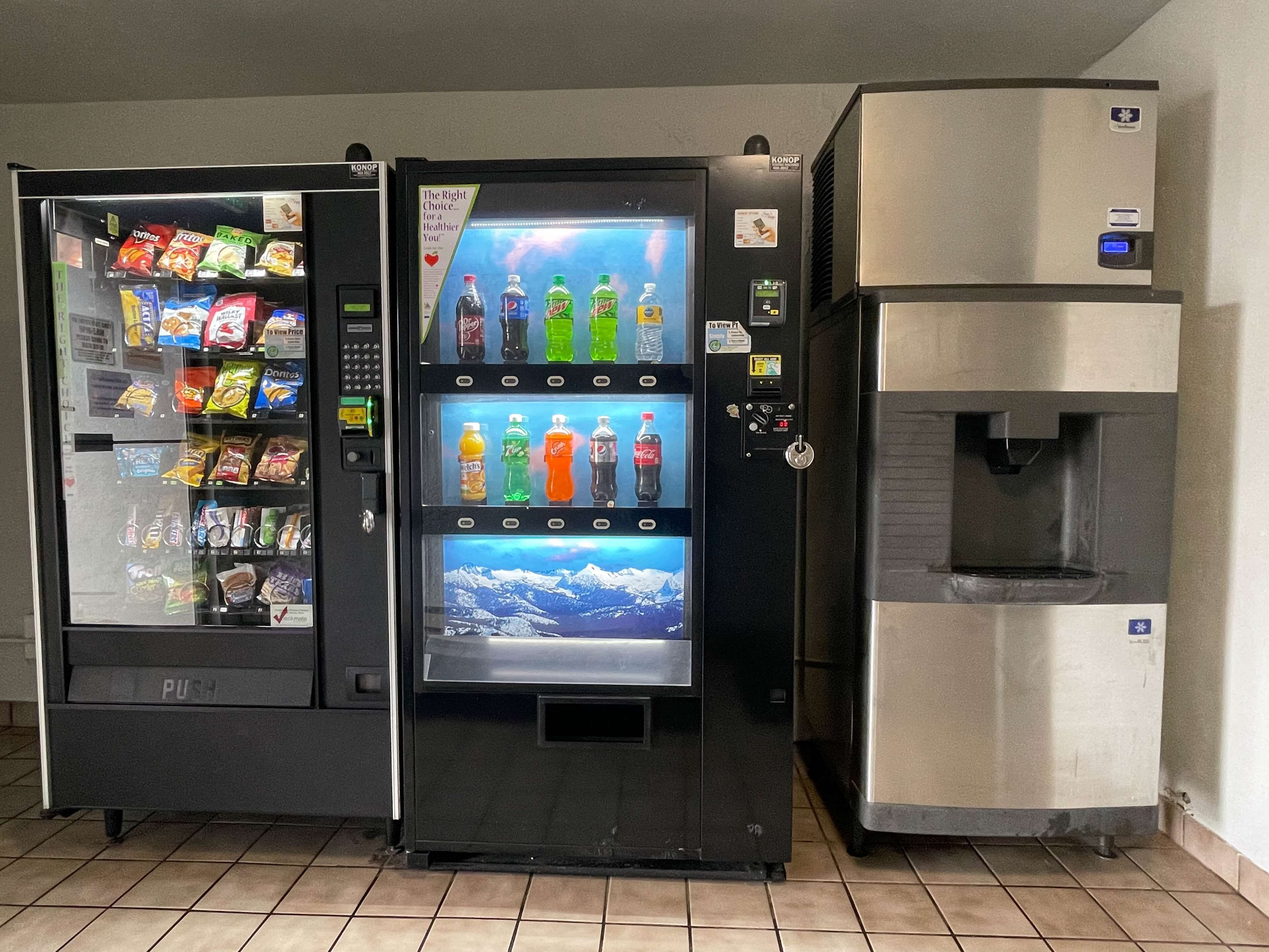 A vending machine with snacks and drinks, a water dispenser, and a digital display.