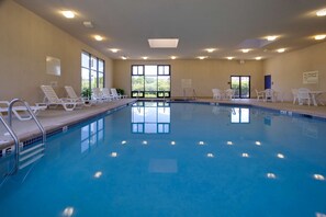 Relax by the pool surrounded by lush greenery and enjoy easy access via the pool ladder.
