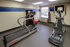 Stay active with a treadmill and elliptical machine, plus a TV and bulletin board for motivation.