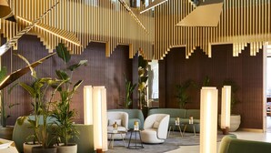 A modern interior with a staircase, seating area, and potted plants. - Grand Hyatt Barcelona (Barcelona)