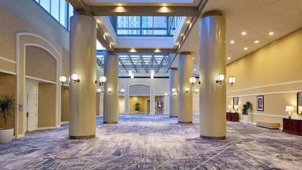 A spacious lobby with high ceilings, large columns, and a patterned carpet. - Marriott Columbia (Columbia)
