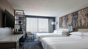 A hotel room with two beds, a desk, a chair, a TV, and a large window with curtains. - Marriott Columbia (Columbia)