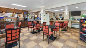 A restaurant with a counter, chairs, and a buffet area. - Best Western Mountainbrook Inn (Maggie Valley)