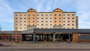 A Westmark hotel with a modern design, featuring a large parking lot and a covered entrance.