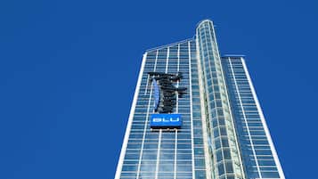 A tall, modern glass building with a prominent 'BLU' sign.