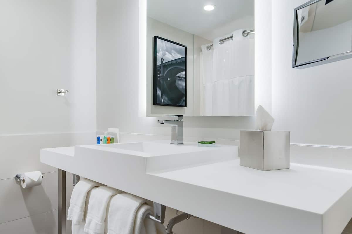 combined shower/bathtub, designer toiletries, hair dryer, towels