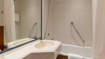 A bathroom with two sinks, a shower, and a bathtub.
